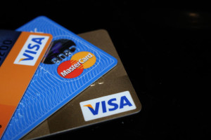 An assortment of colorful credit cards sits on a black surface.