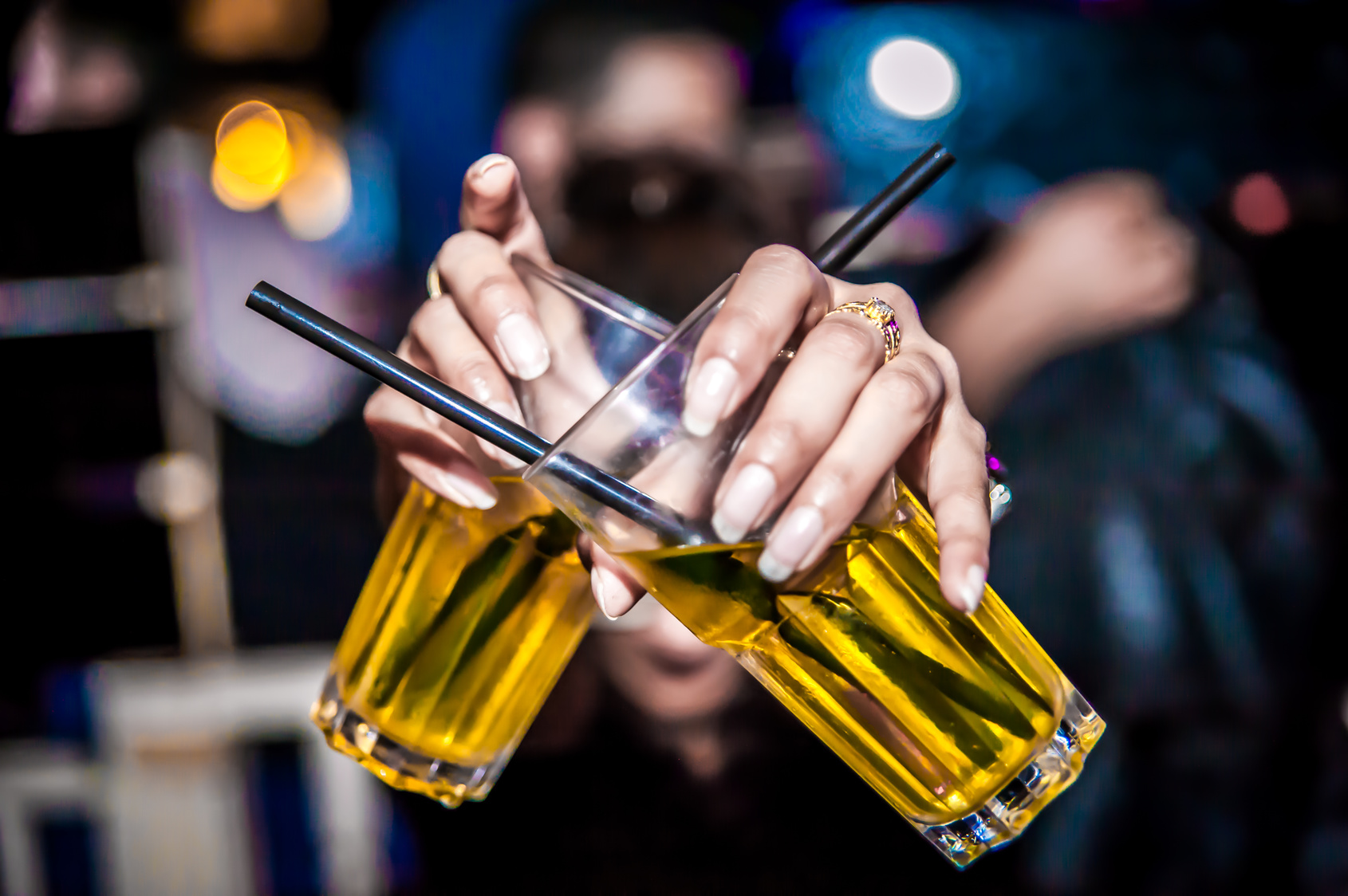 Partiers drink beer out of a straw, for some reason.