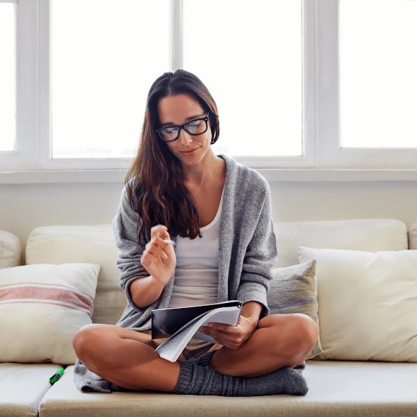 Notebook with a list of self-care coping mechanisms like journaling, walking, and breathing exercises